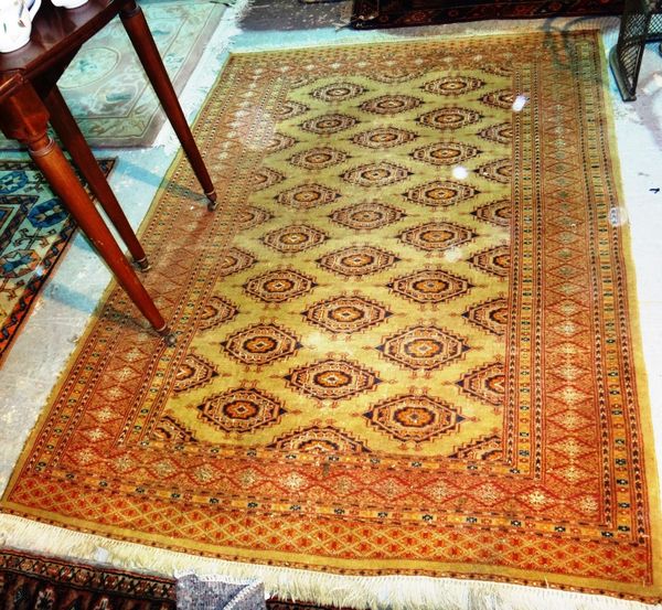 A modern golden Afghan rug.