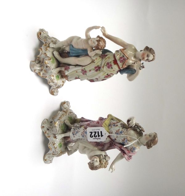 A pair of Sitzendorf porcelain figures, early 20th century, each modelled as a classical female figure with child emblematic of the seasons, 19.5cm hi