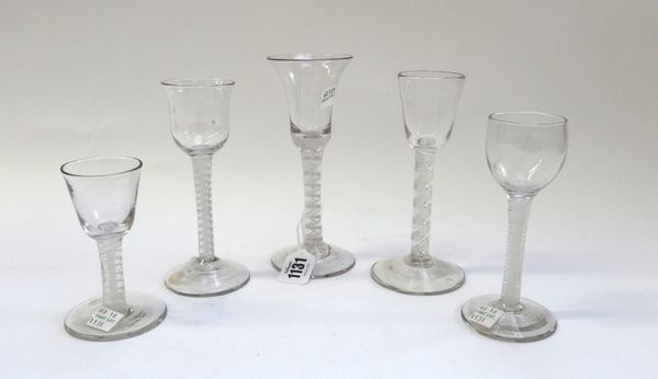 Five wine glasses, circa 1750-65, comprising four with opaque twist stems and one with an airtwist stem.