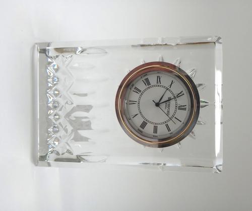 A matched part suite of Waterford crystal, comprising; a decanter and stopper, six tumblers, six smaller tumblers, a clock and a comport (15).