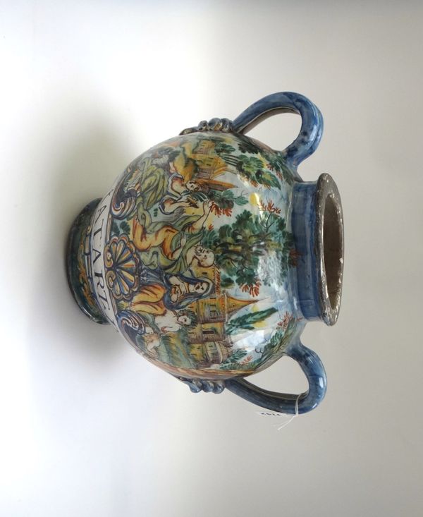 An Urbania maiolica two handled drug jar, 18th century, painted with a family group against a landscape and detailed 'DIATART.PC' (a.f.), 27cm high.