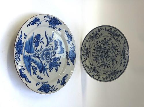 A blue and white tin glazed earthenware dish, possibly Bristol, mid 18th century, painted with a mimosa pattern, 32cm diameter, and one other tin glaz