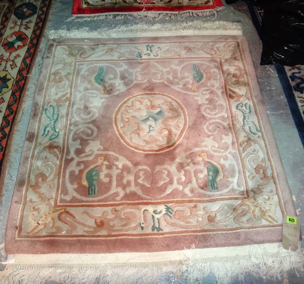 A Chinese rug with a beige field, 100cm x 94cm.