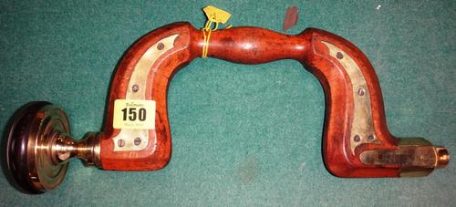 A late Victorian beech and brass mounted carpenter's pad brace with turned ebony pad 34cms wide