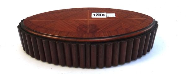 An early 20th century inlaid kingwood oval jewellery box, the reeded sides with four swing out compartments, 29cm wide.