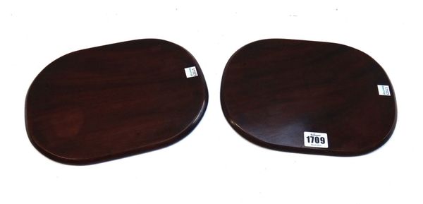 A pair of mahogany coasters of rounded rectangular form, probably late 18th/early 19th century, each 26cm wide.