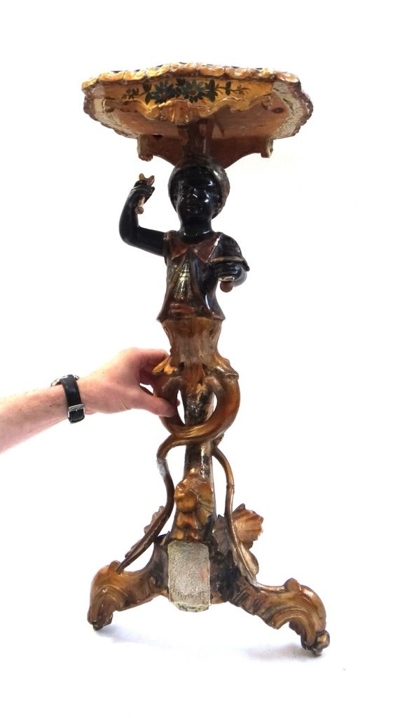 An early 20th century polychrome painted parcel gilt jardiniere stand with blackamoor figural supports, 74cm high, (a.f.).