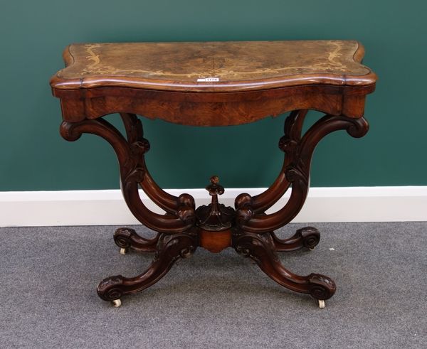 A Victorian figured walnut marquetry inlaid card table, with serpentine top on four opposing 'C' scroll supports, 92cm wide.