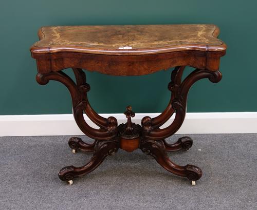 A Victorian figured walnut marquetry inlaid card table, with serpentine top on four opposing 'C' scroll supports, 92cm wide.