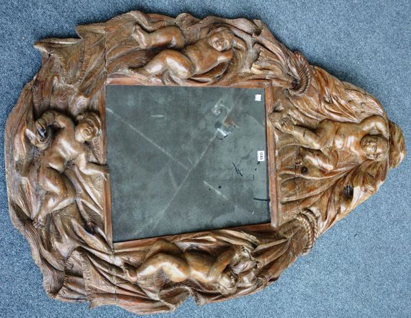 A 17th century Italian wall mirror in an extensive carved pine frame decorated with recumbent cherubs, 120cm x 90cm.