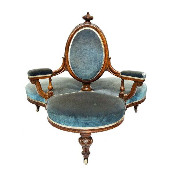 A Victorian three seat conversation sofa, with oval back and bow seat, on turned and fluted supports.  Illustrated