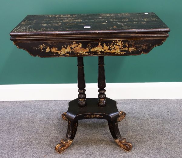 A 19th century Chinese black lacquer chinoiserie decorated card table, with single frieze drawer on turned columns, quatrefoil platform and four scrol