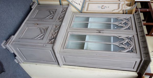 A cream painted display cabinet cupboard, the pair of Gothic astragal glazed doors over pair of drawers and panel cupboards, on ogee bracket feet, 116