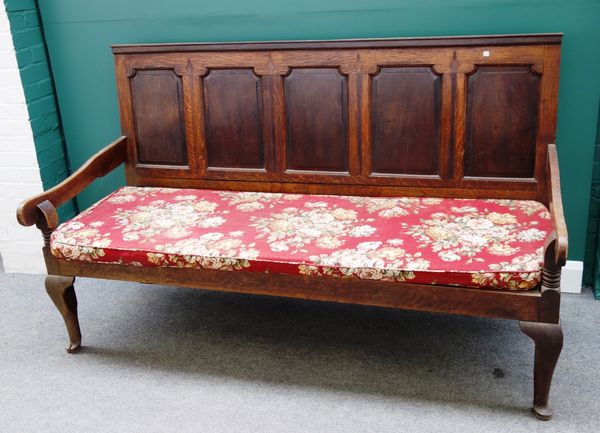 An 18th century inlaid oak settle, with five panel back and open arms, on cabriole supports, 187cm wide.