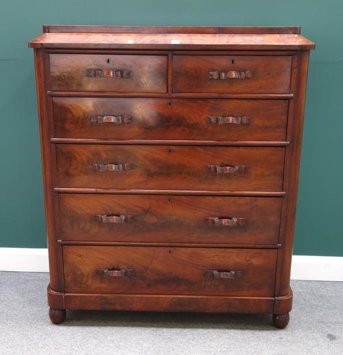A 19th century mahogany chest, the caddy top over two short and four long graduated drawers, each with carved ribbon handles, on bun feet, 121cm wide.