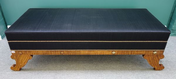 A large Empire style gilt metal mounted satinwood rectangular footstool, on sabre supports, 166cm wide.