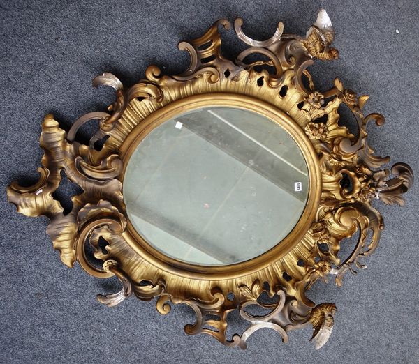 A 19th century Italian gilt framed wall mirror, with floral chased acanthus scroll border mounted with birds of paradise, 120cm wide x 130cm high.