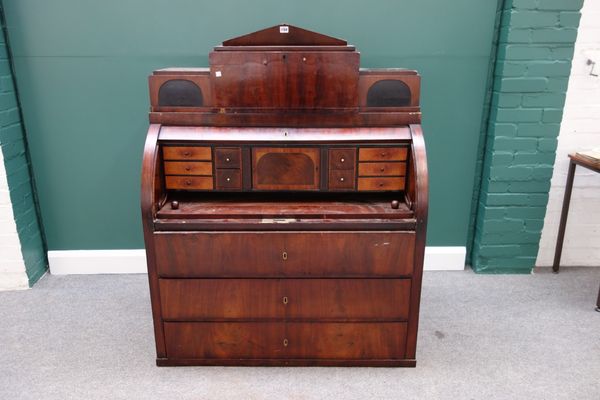 A 19th century mahogany cylinder bureau, the fitted three drawer architectural super structure over cylinder front, also containing a fitted interior,