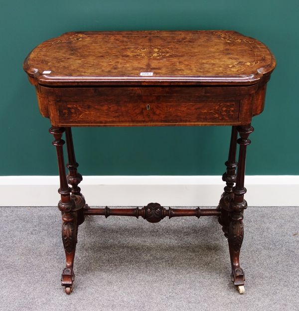 A Victorian marquetry inlaid figured walnut games sewing table, the flip top revealing inlaid playing surfaces over frieze drawer, on four fluted supp