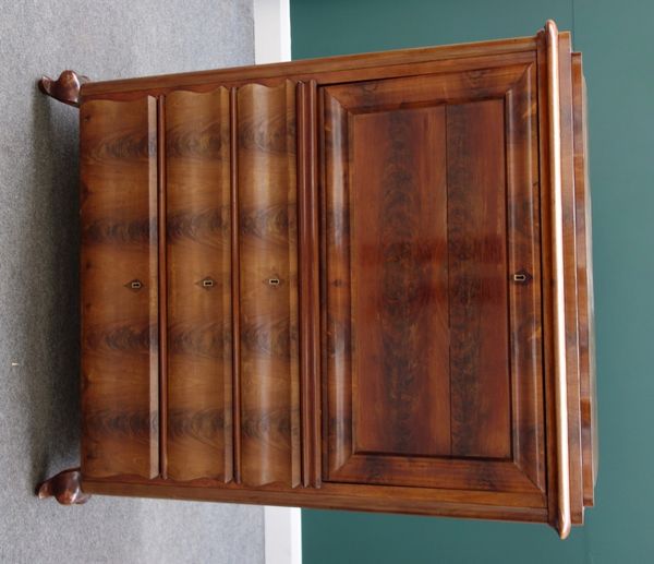 A 19th century North European mahogany secretaire a abattant, the fall revealing a fitted interior over three shaped long drawers, on squat cabriole s