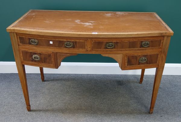 A 19th century inlaid mahogany bowfront writing table with four drawers about the knee, on tapering square supports, 116cm wide.