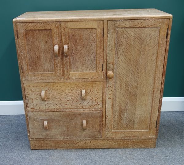 A Heals limed oak side cabinet with an arrangement of three panel doors and pair of drawers, on plinth base, 100cm wide x 99cm high.