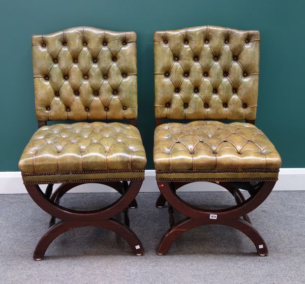 A set of ten 18th century style studded green leather upholstered dining chairs, with humped crest on 'X' frame mahogany supports.