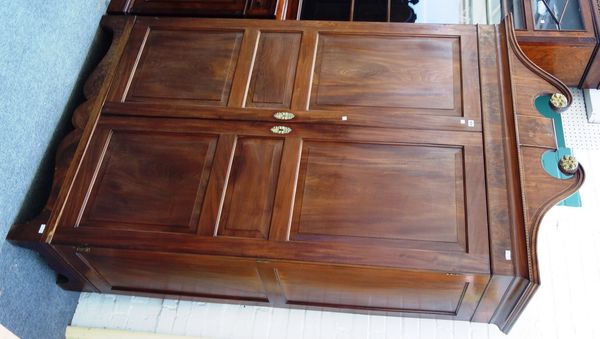 A George III gilt metal mounted mahogany 'Jersey' wardrobe, the broken swan neck cornice over pair of panel doors, on bracket feet, 137cm wide x 207cm