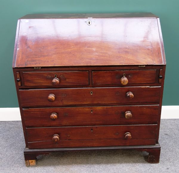 A George III mahogany bureau, the fall enclosing a fitted interior over two short and three long graduated drawers, on bracket feet, 101cm wide.