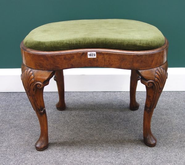 An 18th century style walnut framed kidney shaped stool on four cabriole supports, 61cm wide.