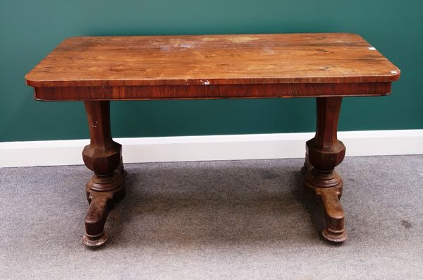 An early Victorian rosewood centre table, the rounded rectangular top with single frieze drawer on pair of flared octagonal columns, 140cm wide.