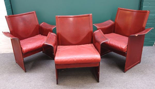 A set of three 20th century Italian rouge leather upholstered armchairs by Matteo Grassi.