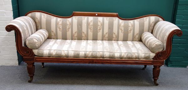 A Regency mahogany framed sofa with scroll ends and straight seat, on spiral fluted supports, 220cm wide.