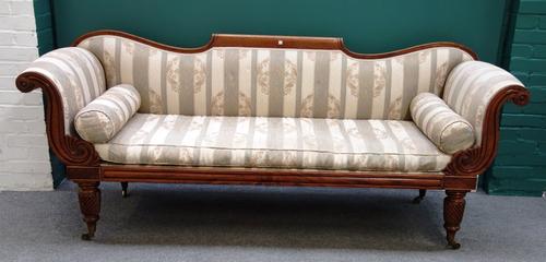 A Regency mahogany framed sofa with scroll ends and straight seat, on spiral fluted supports, 220cm wide.