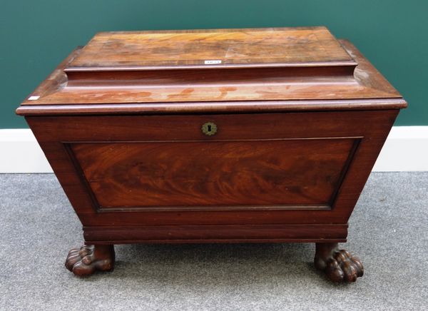 A Regency mahogany cellerette of sarcophagus form, on lions paw feet, 72cm wide.