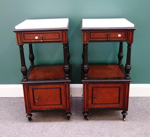 A pair of 19th century French amboyna and ebonised bedside tables, each with marble top over single drawer, on fluted columns and lower cupboard, each