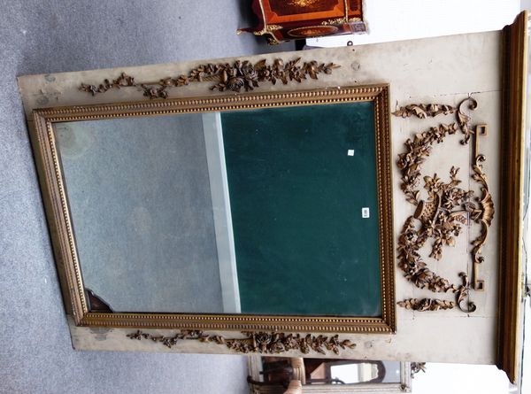 A 19th century French gilt framed wall mirror, the cream painted back panel relief gilt decorated with flowering horns and baskets about the rectangul