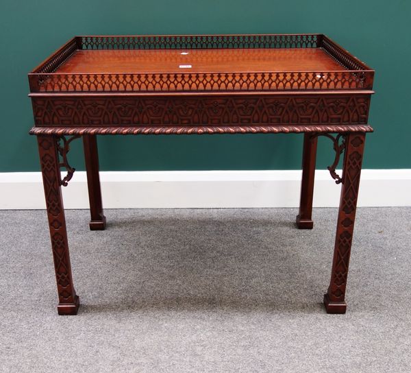 An 18th century Chippendale style silver table, with open fret carved gallery over blind fret carved frieze and canted square supports, 78cm wide.