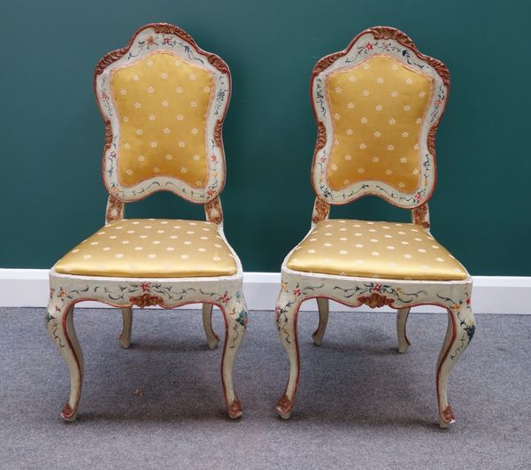 A set of four late 19th century Italian polychrome painted side chairs, with serpentine crest rails and bow seats, on cabriole supports.