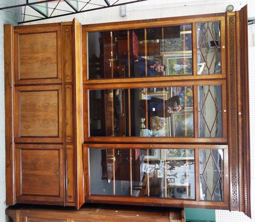 A Victorian rosewood bookcase/cupboard with three glazed doors over three drawers and cupboards on plinth base 220cm wide x 273cm high.