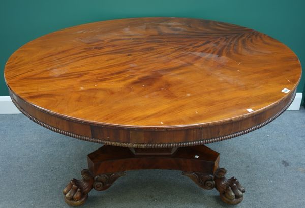 An early Victorian mahogany circular snap top breakfast table, on tapering octagonal column, triform platform and three lions paw feet, 139cm wide.