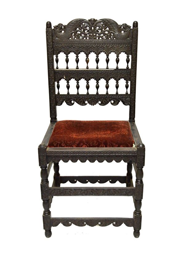 A 17th century Anglo Indian ebony side chair, with carved and turned decoration and drop in seat, 115cm high.  IllustratedFootnote:  Similar examples