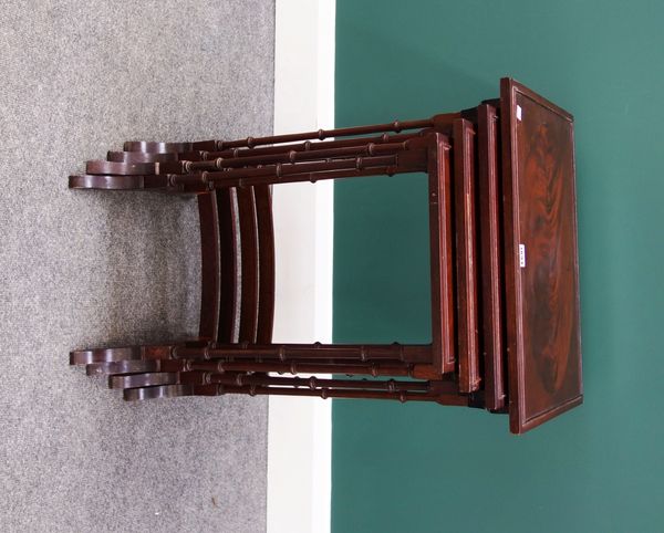 A nest of four mahogany occasional tables, on turned supports united by convex stretchers, the largest 50cm wide.