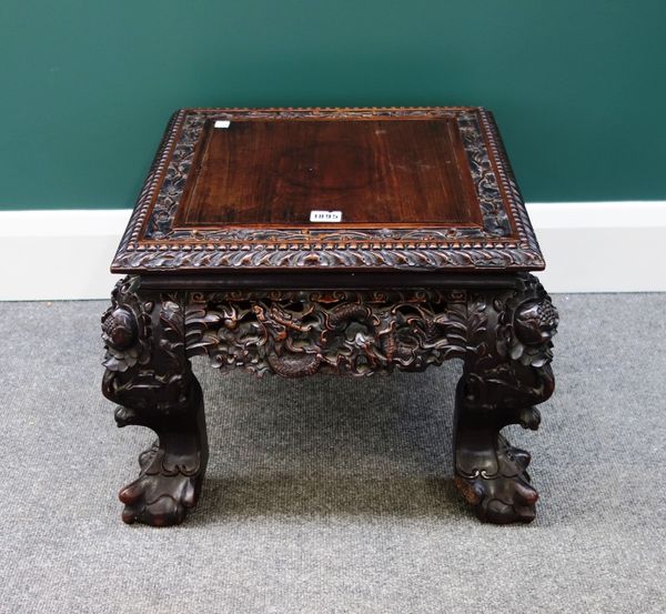 A late 19th century Chinese square hardwood urn stand, the pierced and carved frieze depicting dragons chasing pearls, on ball and claw feet, 48cm wid