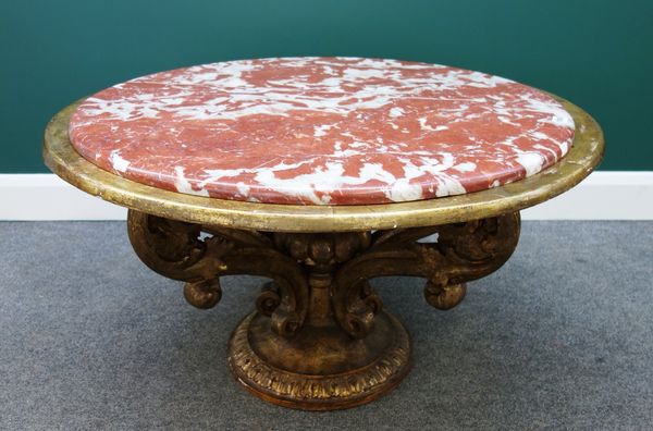 A 20th century Italian low centre table, the circular rouge marble top on four giltwood open acanthus scrolls, on a circular base, 95cm wide.