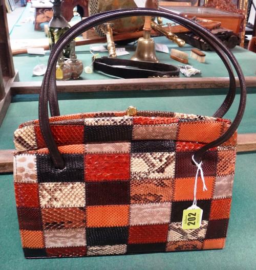 A 1970's faux snakeskin and leather patchwork clutch bag by Hilmar Manchester, label to interior, 32cms wide