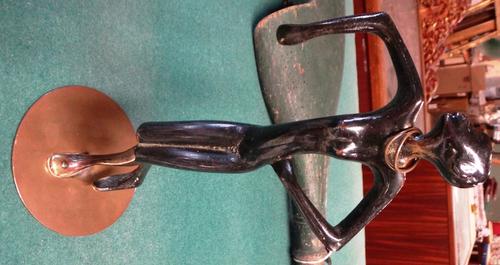 A patinated bronze figure of a female African dancer attributed to Karl Hagenauer, cast bronze with applied brown patina, circular metal neck ornament