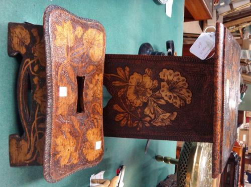 A pokerwork table/stool, hinged lid above tapering sides with Moorish cut out base, richly floral decorated all over, 41cms high; and a similarly deco