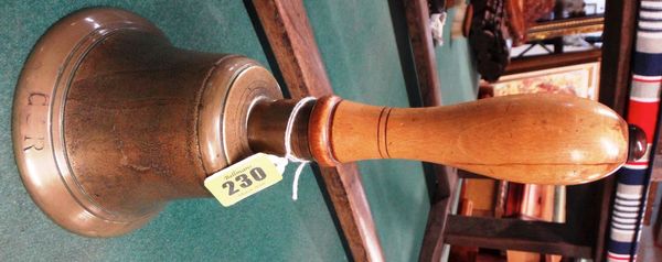 A 20th century hand bell, turned beech handle and tapering swept bell marked "GR", 25cms high