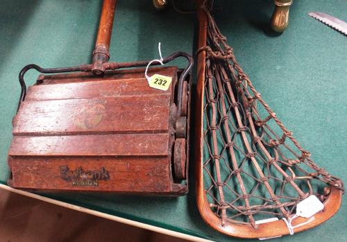 A vintage Ewbank Albion oak carpet sweeper, 122cms high; and a hickory and rawhide lacrosse stick Viktoria No 2 by Hattersley & Son Manchester, 113cms